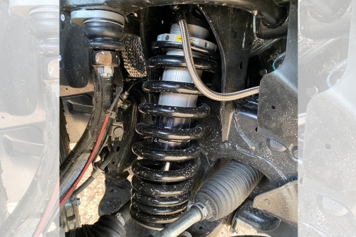 Steering and suspension repair in Grand Junction, CO at Barney Brothers Off Road and Repair. Image of a black suspension components undergoing maintenance for steering and suspension.