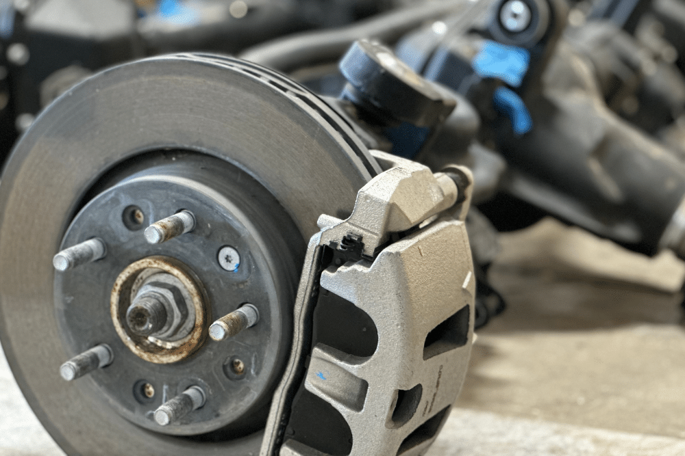 Brake Pad and Disc Brake Services in Grand Junction, CO, 81505, by Barney Brothers Off Road and Repair. Image of a close-up view of a vehicle's brake system, showing a disc brake and brake pad assembly during maintenance, highlighting Barney Brothers' expertise in ensuring efficient and safe braking for all types of vehicles.