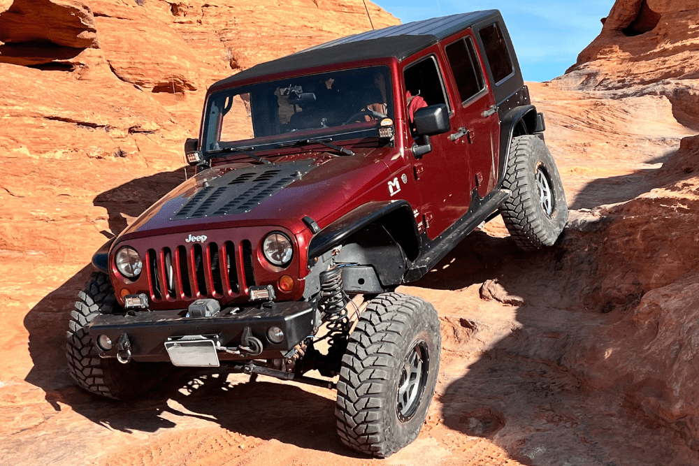 4x4 Repair in Grand Junction, CO by Barney Brothers Off Road and Repair. Image of a lifted Jeep navigating rocky terrain, showcasing performance upgrades built for safety, traction, and extreme adventure.