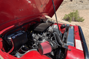 Truck performance shop in Grand Junction, CO by Barney Brothers Off Road & Repair. Image of a modified engine bay with a performance air intake installed, highlighting custom upgrades, diagnostics, and reliable off-road vehicle performance.