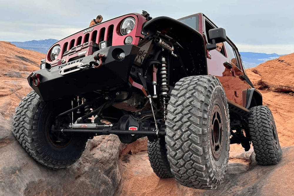 Custom lift installation in Grand Junction, CO by Barney Brothers Off Road & Repair. Image of a lifted Jeep tackling rugged terrain, showcasing high-performance suspension upgrades, durability, and precision off-road capability.